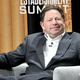 Bobby Kotick sits in a chair, smirking.